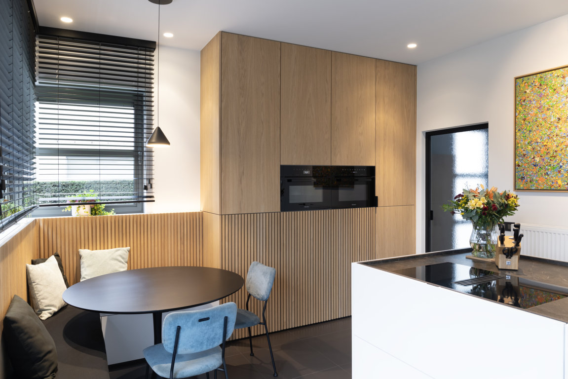 Totaalrenovatie leefruimtes met één volume voor haardmeubel en keukeneiland
